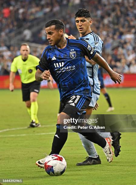 Miguel Trauco of San Jose Earthquakes dribbles the ball against Alan Pulido of Sporting Kansas City in the second half on August 26, 2023 at...