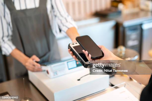 simplified payments automating invoicing and boosting efficiency to enhancing financial management in your business operations. close-up shot of a female hand using her smartphone to scan and pay via nfc method for a bill at the restaurant. - marketing funnel stock pictures, royalty-free photos & images