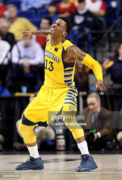 Vander Blue of the Marquette Golden Eagles reacts after a play in the second half against the Butler Bulldogs during the third round of the 2013 NCAA...