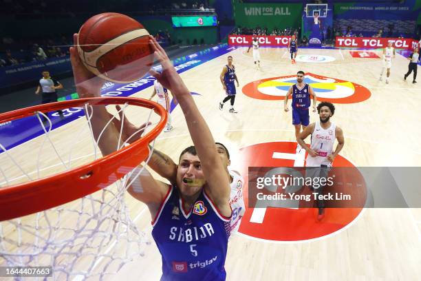 Nikola Jovic of Serbia dunks the ball against Tremont Waters of Puerto Rico in the fourth quarter during the FIBA Basketball World Cup Group B game...