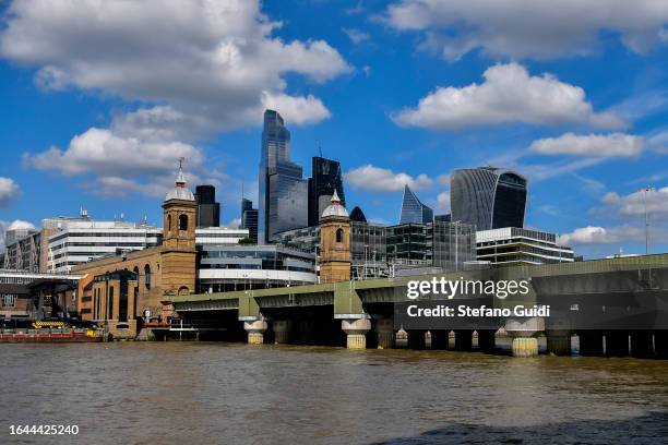 General view of Skyscrapers of the City of London and Cannon Street Railway Bridge seen from Bankside on August 21, 2023 in London, England. London...