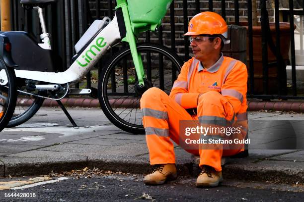 Worker resting near a building site on Redcross Way on August 21, 2023 in London, England. London is the capital of England, many of the inhabitants,...