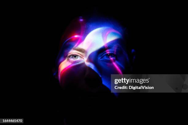 colorful lights on woman's face - projectie stockfoto's en -beelden