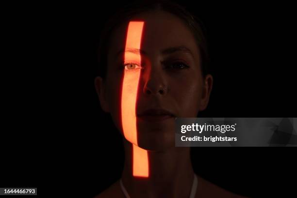 light line on woman's face - face projection stock pictures, royalty-free photos & images