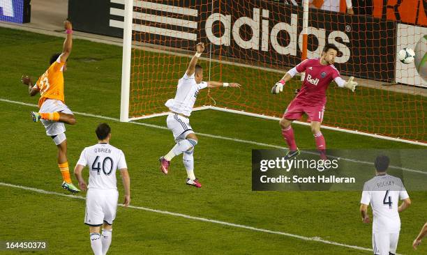 Giles Barnes of the Houston Dynamo scores a goal past Joe Cannon of the Vancouver Whitecaps during an MLS match at BBVA Compass Stadium on March 23,...