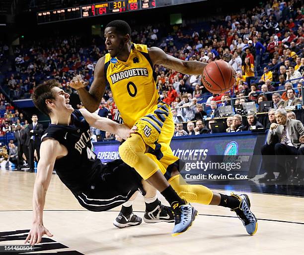Jamil Wilson of the Marquette Golden Eagles drives against Andrew Smith of the Butler Bulldogs in the second half during the third round of the 2013...