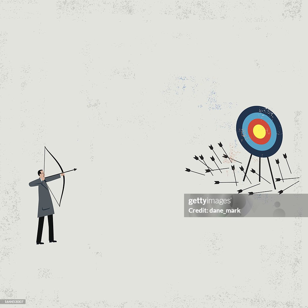 Businessman shooting arrows