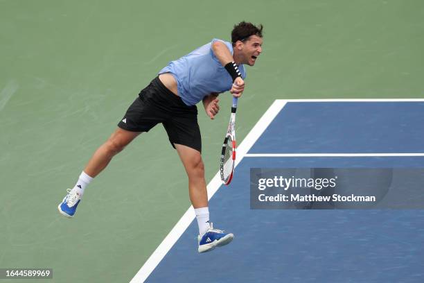 Dominic Thiem of Austria serves against Alexander Bublik of Kazakhstan during their Men's Singles First Round match on Day One of the 2023 US Open at...