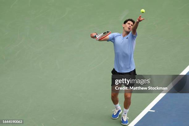 Dominic Thiem of Austria serves against Alexander Bublik of Kazakhstan during their Men's Singles First Round match on Day One of the 2023 US Open at...