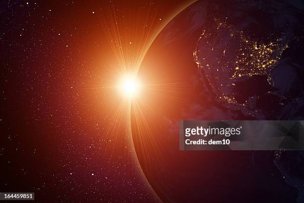 sol naciente detrás del planeta - satellite view fotografías e imágenes de stock