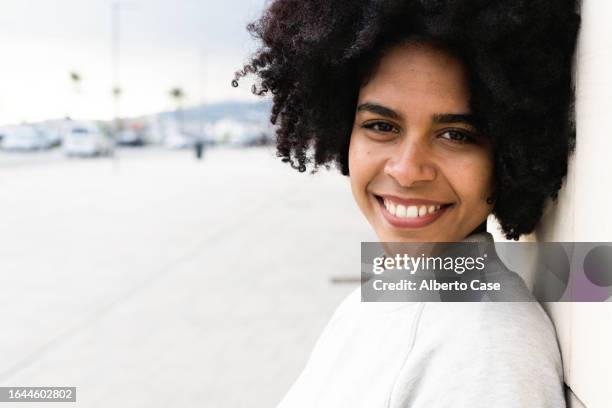 young black woman smiling at camera in the street - close up portrait stock pictures, royalty-free photos & images