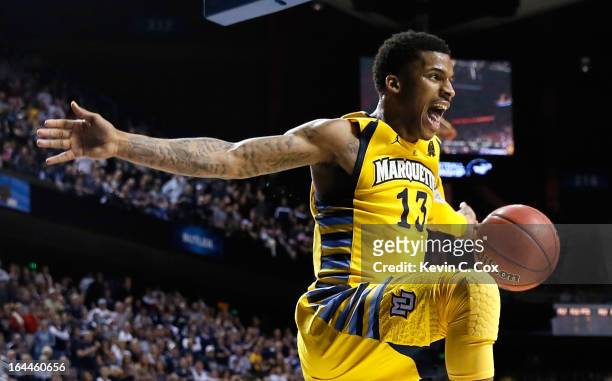 Vander Blue of the Marquette Golden Eagles reacts after stealing the ball and a dunk against the Butler Bulldogs in the second half during the third...