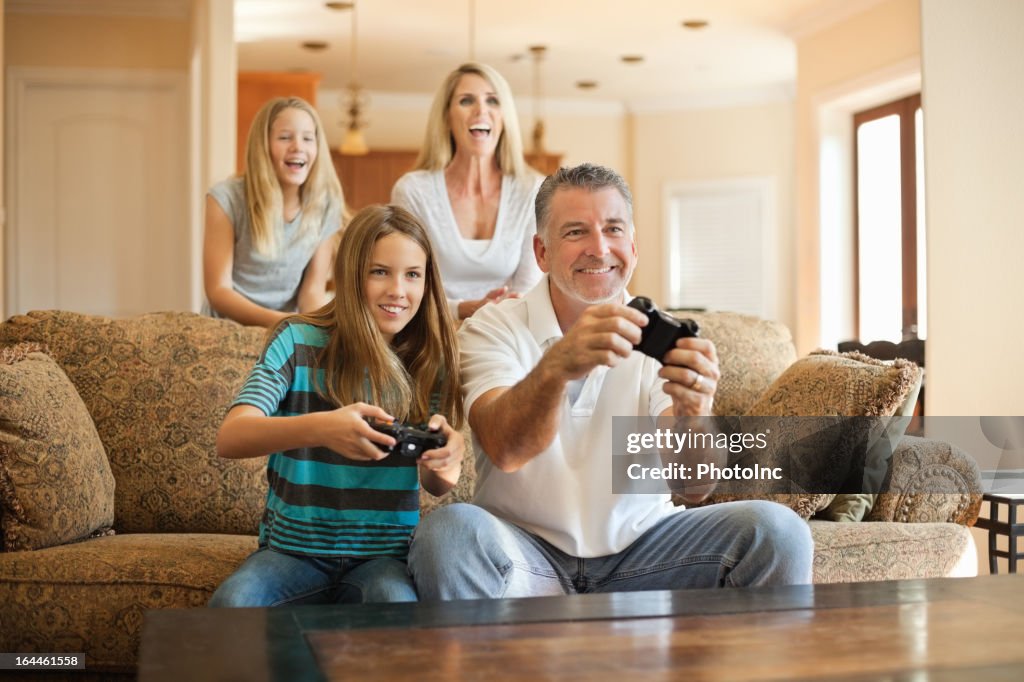 Happy Caucasian family having fun playing videogames