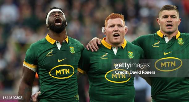 Siya Kolisi, the South Africa captain, Steven Kitshoff and Malcolm Max sing their national anthem during the Summer International match between New...