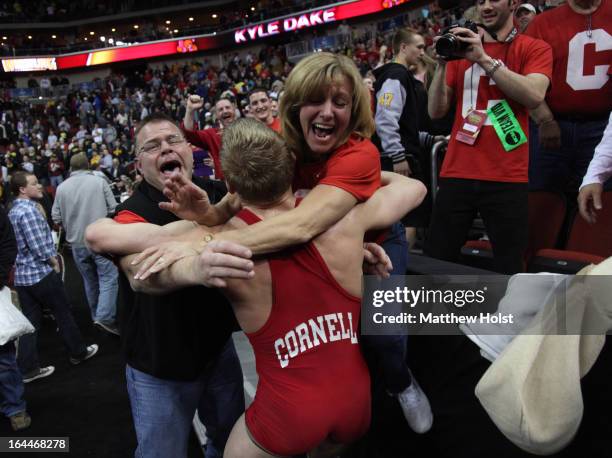 Des Moines, IAKyle Dake of the Cornell Big Red hugs his parents Doug and Jodi Dake, of Lansing, NY, after his victory over David Taylor of the Penn...