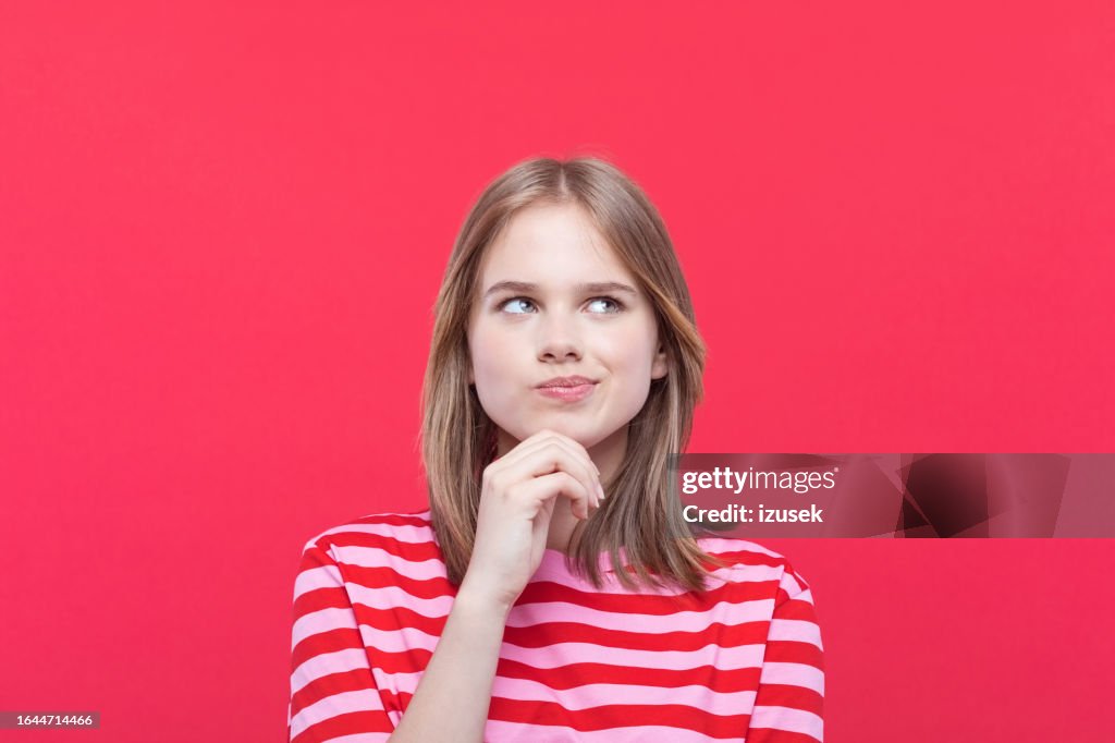 Portrait of confused teenage girl