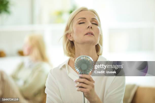 conflict between a mother and her teenage daughter - hand fan stock pictures, royalty-free photos & images