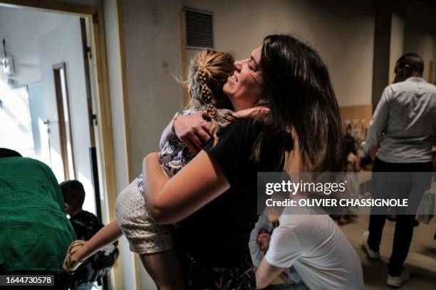 Mother hugs her daughter as they arrive at the new Wangari Maathai elementary school for the first day of the new academic year, on September 4, 2023...