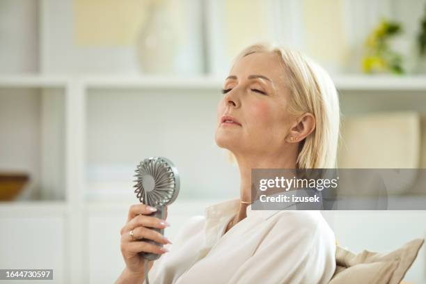 portrait of menopausal mature woman - hand fan stock pictures, royalty-free photos & images