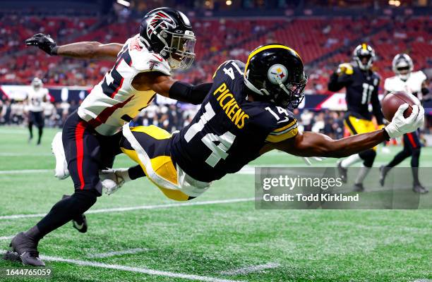 George Pickens of the Pittsburgh Steelers leaps for a reception over Natrone Brooks of the Atlanta Falcons during the first quarter of a preseason...