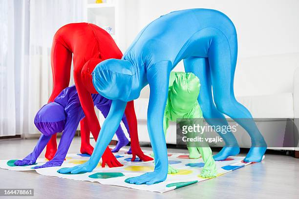 family playing floor game. - bodysuit stock pictures, royalty-free photos & images