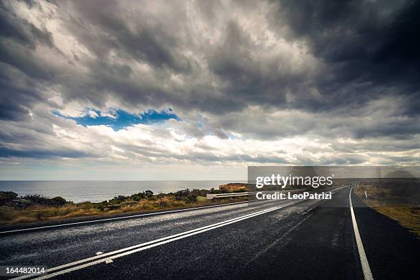 empty road - australia storm stock pictures, royalty-free photos & images