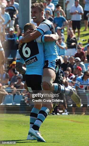 Todd Carney of the Sharks celebrates with Beau Ryan after scoring a try during the round three NRL match between the Cronulla Sharks and the New...