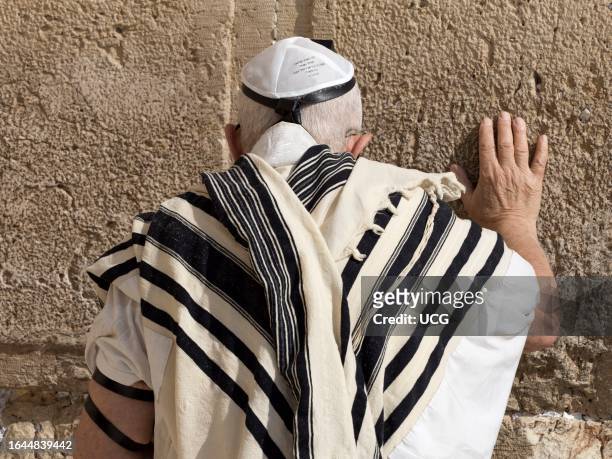 Praying at the Western Wall in the Old City of Jerusalem, Israel.