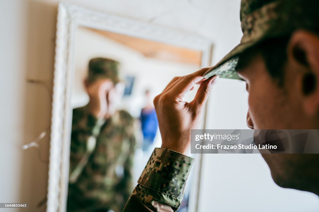 Close-up of an army soldier putting on cap