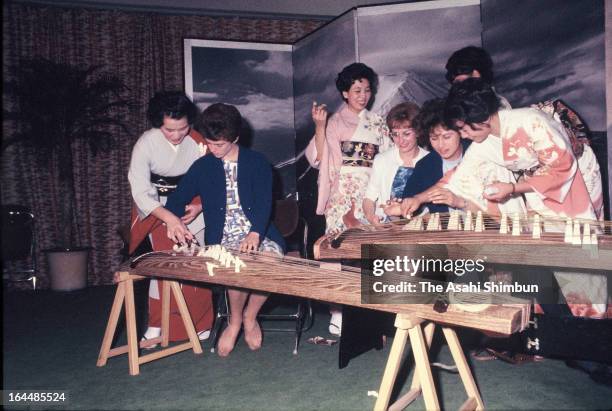 Athletes try Japanese harp as a part of cultural exchange session in the Athletes Village ahead of Tokyo Olympic on October 1, 1964 in Tokyo, Japan.