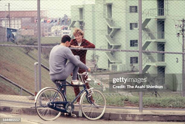 Athletes talk over the fence between male and female village in the Athletes Village ahead of Tokyo Olympic on October 1, 1964 in Tokyo, Japan.