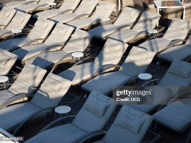 Deckchairs and my shadow on a cruise ship in the Mediterranean.