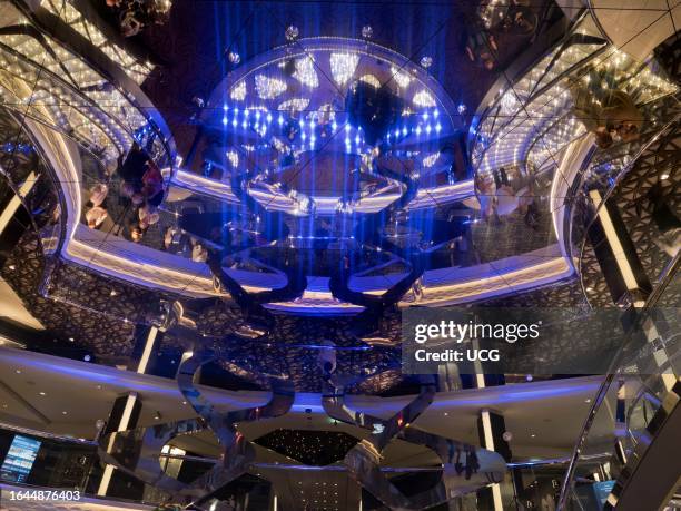 Glitzy atrium and shopping arcade of a ocean liner cruising the North Sea.