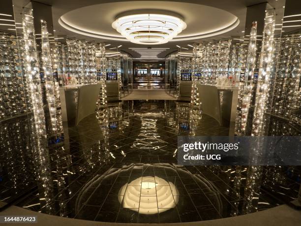 Glittering hall of wine racks in an ocean liner cruising the North Sea.