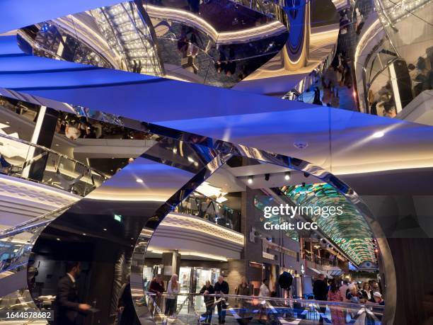 Glitzy atrium and shopping arcade of a ocean liner cruising the North Sea.
