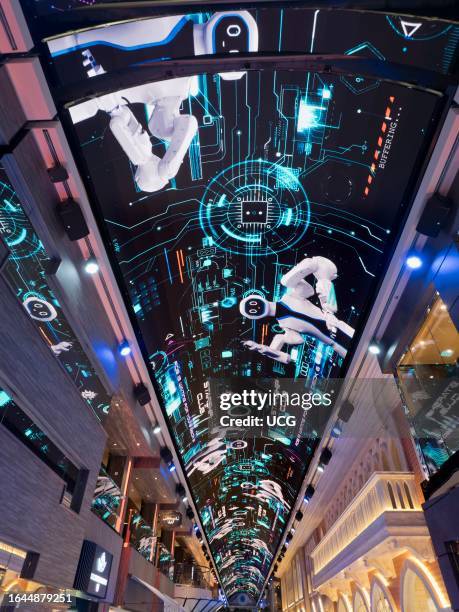 Glitzy shopping arcade and video ceiling of a ocean liner cruising the North Sea.