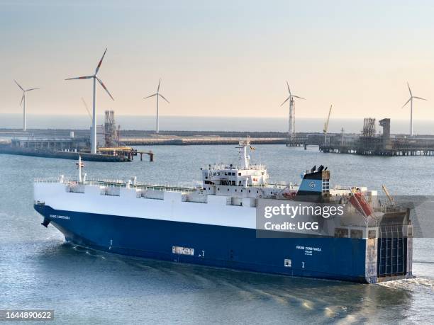 Wind farm and passing ferry in Zeebrugge, Belgium.