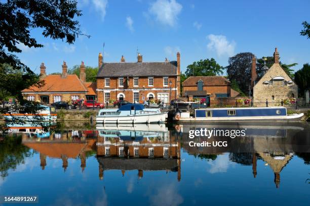 St Helens Wharf, Abingdon, with floral displays and moored pleasure boats on a fine summer morning.