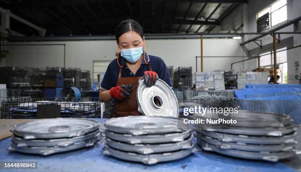 Worker produces automotive suspension and shock absorber support products in a car workshop on September 4, 2023 in Huai'an, Jiangsu, China.