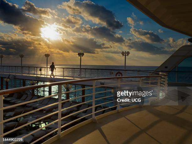 Strolling on the running track of a cruise liner as it cruises the Mediterranean at sunset.