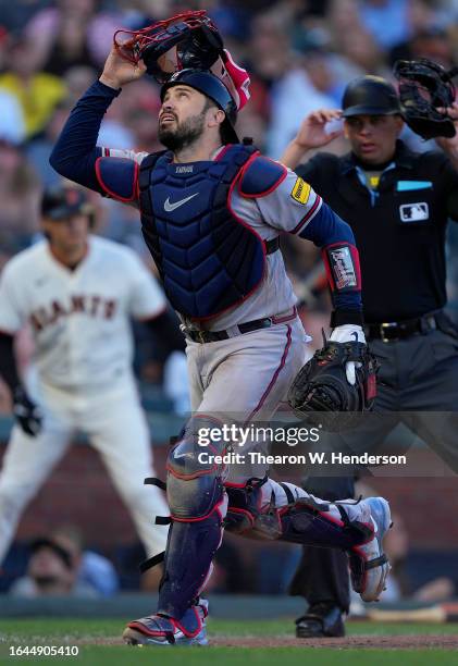 Travis d'Arnaud of the Atlanta Braves tracks a foul pop-up hit by Thairo Estrada of the San Francisco Giants in the bottom of the fifth inning at...
