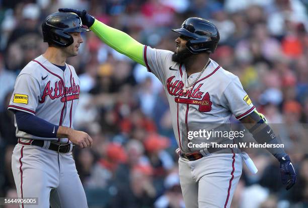 Marcell Ozuna and Matt Olson of the Atlanta Braves celebrates after Ozuna hit a two-run home run against the San Francisco Giants in the top of the...