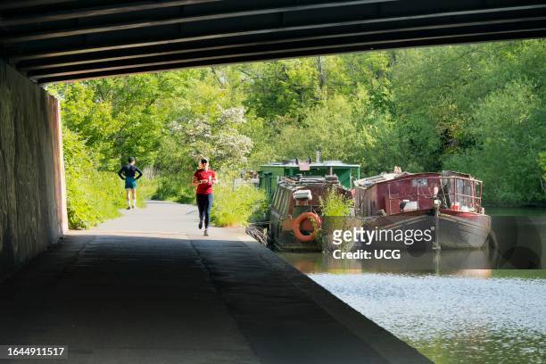 Jogger passing under bridge over the Thames at Iffley.
