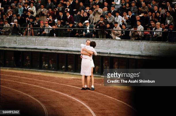 Kenneth Metthews of Great Britain hugs with his wife after winning the gold medal in the Men's 20km Walk during Tokyo Olympic at the National Stadium...