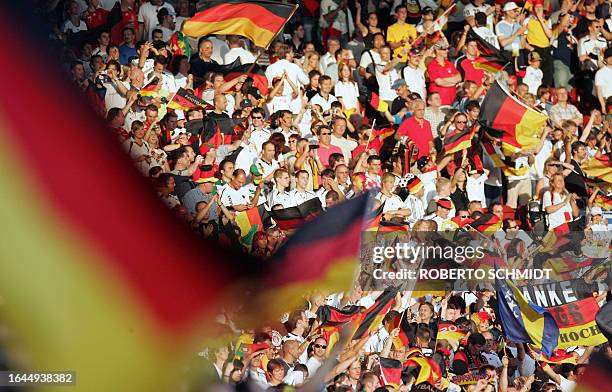 German supporters cheer their team as they wait for the start of the World Cup 2006 third place play-off football game Germany vs.Portugal, 08 July...