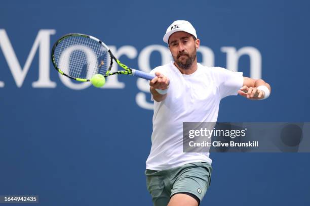 Steve Johnson of the United States returns a shot against Taylor Fritz of the United States during their Men's Singles First Round match on Day One...