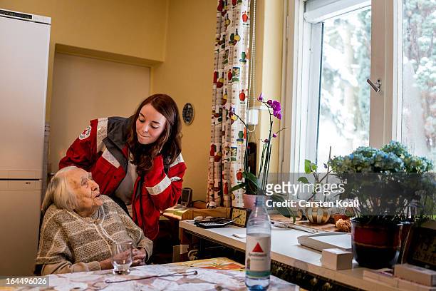 Annie Therre , who works for the German Red Cross , makes a visit to 100-year-old senior citizen Frida Fiedler in order to illustrate the emergency...