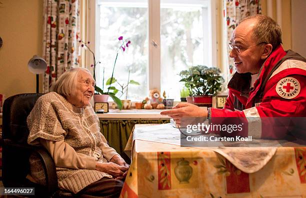 Harald Gross , who works for the German Red Cross , makes a visit to 100-year-old senior citizen Frida Fiedler in order to illustrate the emergency...