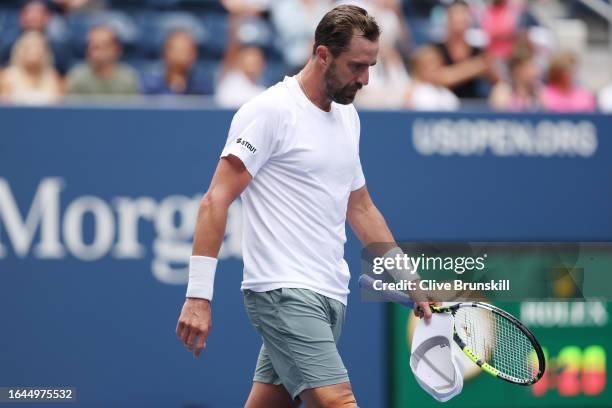 Steve Johnson of the United States reacts after being defeated by Taylor Fritz of the United States during their Men's Singles First Round match on...