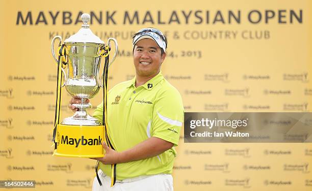 Kiradech Aphibarnrat of Thailand celebrates with the trophy after winning the 3rd and final round of the Maybank Malaysian Open at Kuala Lumpur Golf...